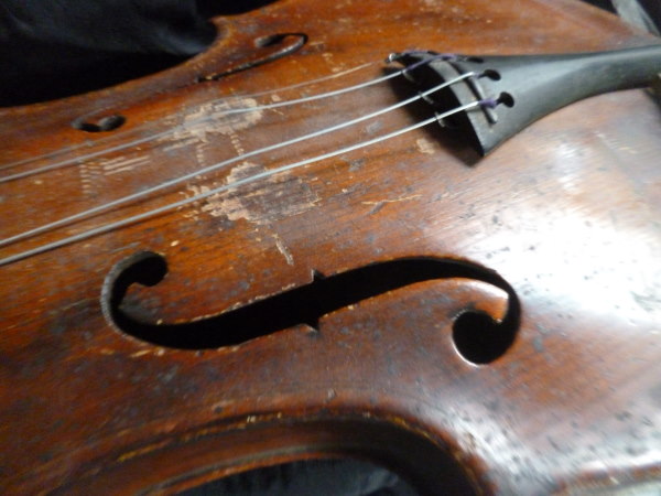 The scroll work on the front of the antique violin