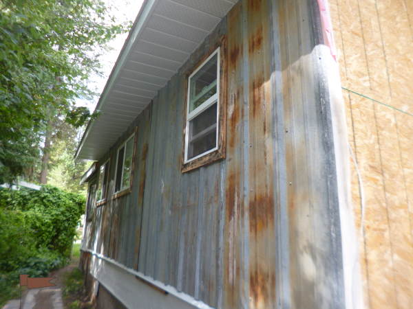 Ribbed metal roofing, flattened