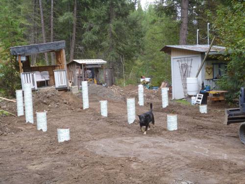 Buck checks out the backfilled Big Foots with Sonotubes showing